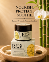 R&3U Restorative Salve jar and box displayed on a wooden tray with spa stones, white orchids, and bamboo in the background. Text reads: 'NOURISH. thumbnail 1